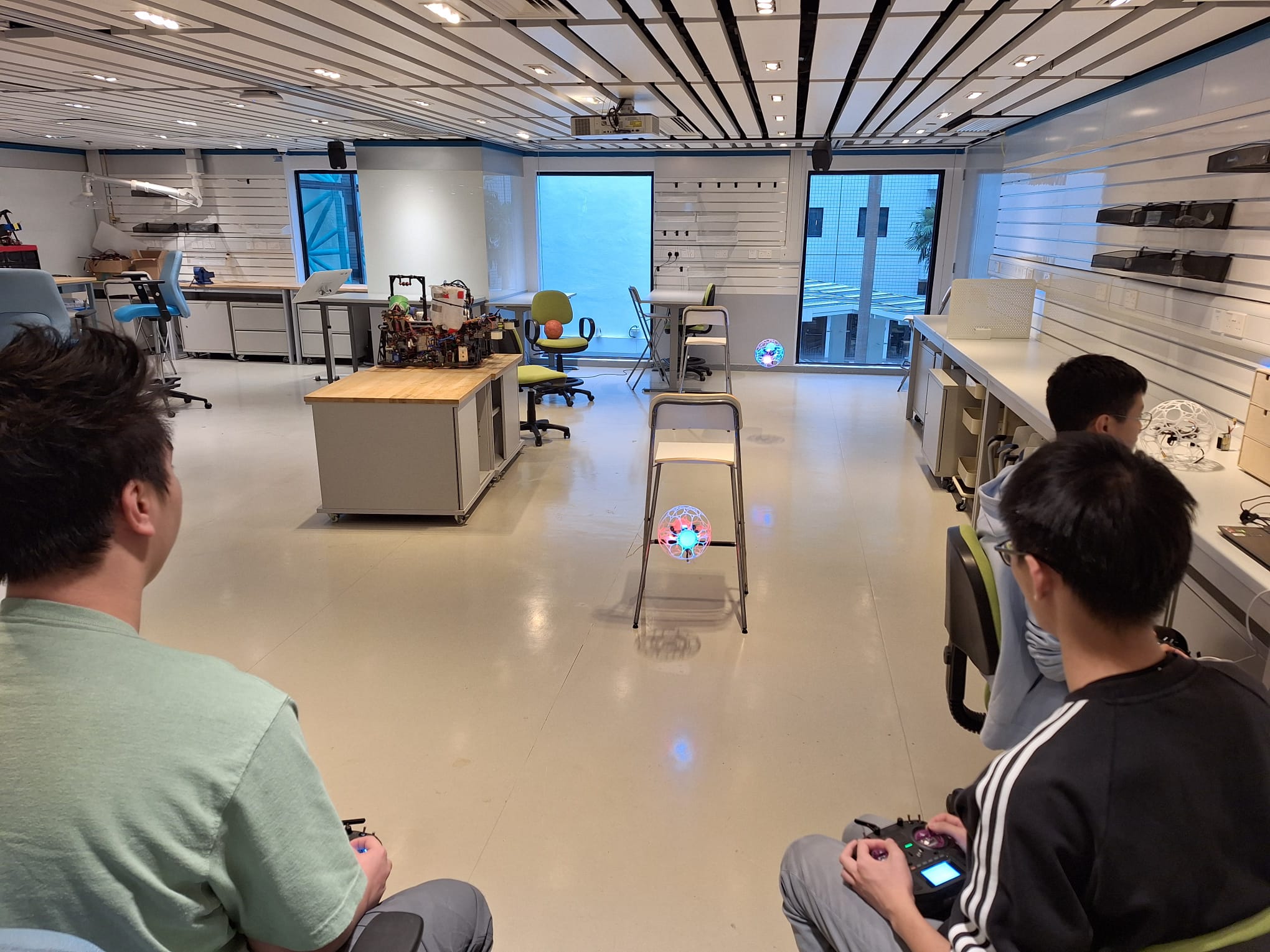 Adult learners practising drone flight in a workshop setting