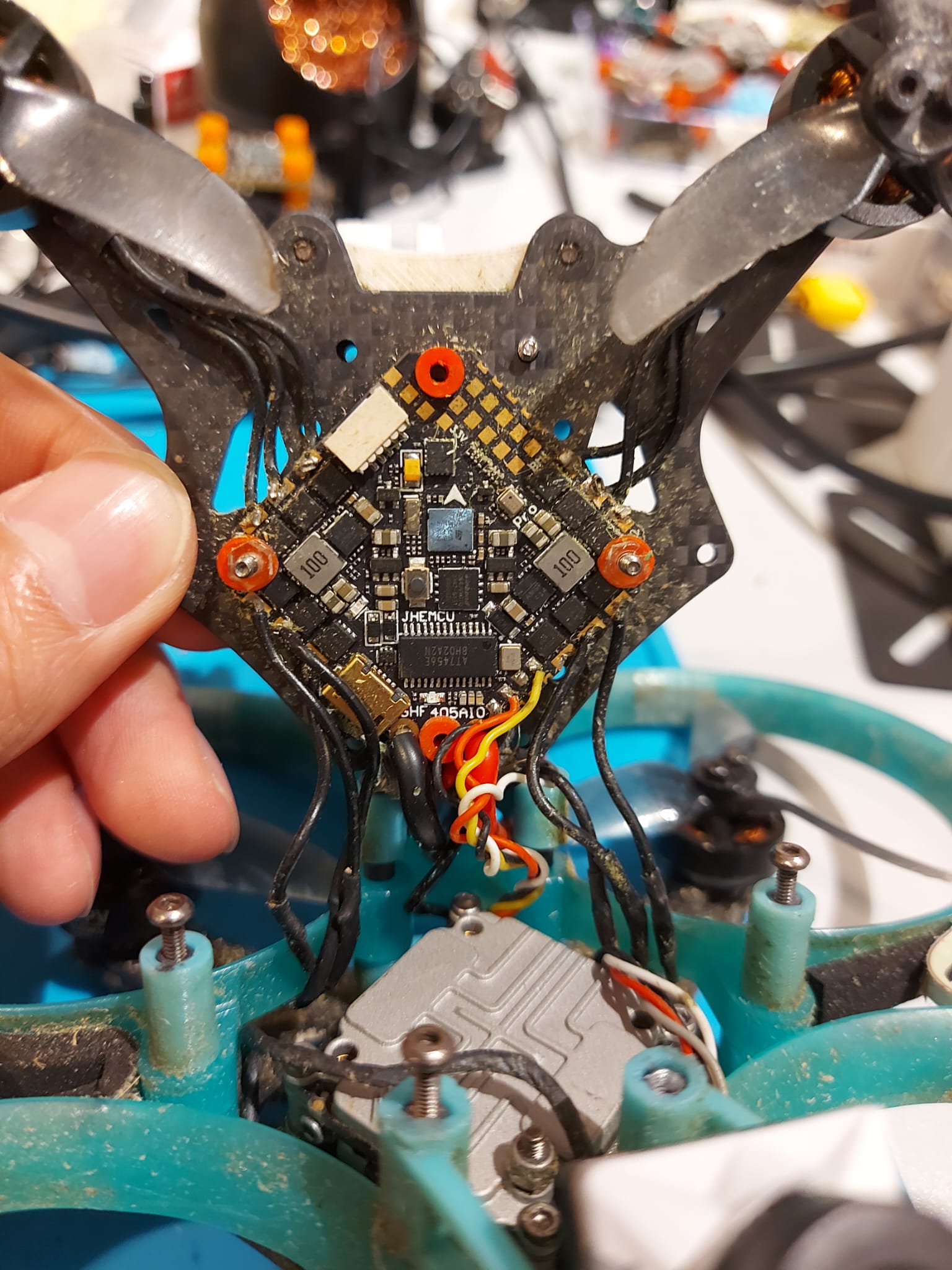 Drone flight controller being inspected during a repair assessment